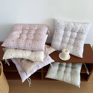 Detail of floral and plaid thickened chair cushions with practical non-slip tie strings