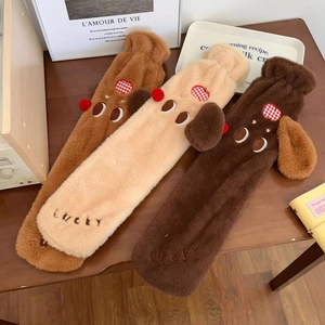 Detail of plush dachshund hot water bottles with 'lucky' embroidery and soft long fur