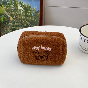 Close-up of cute embroidered bear face on brown teddy fleece travel cosmetic storage bag