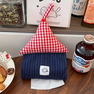 Detail of a house-shaped fabric tissue box holder with red gingham and blue stripes