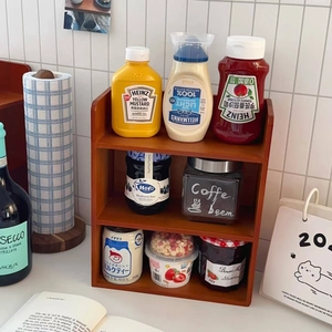 Detailed view of a three-tier dark wood desk organizer used for kitchen spice storage