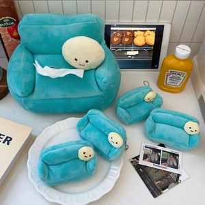 Detail of soft green plush sofa tissue box cover with cute cartoon faces in a cozy setting