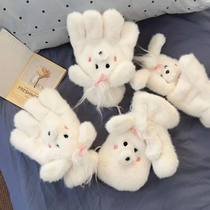 Detail of plush white fleece gloves with pink bows and cartoon rabbit faces