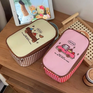 Detailed view of insulated lunch bags with dog and cat patterns on a wooden shelf