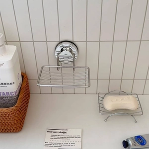 Detail of suction cup wall mount and standing stainless steel wire soap dishes
