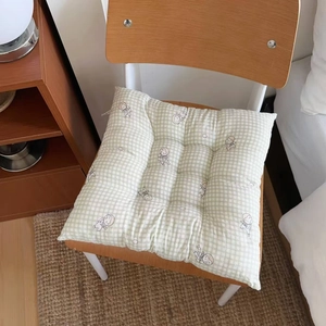 Detail of green checkered seat cushion with cartoon rabbit and secure chair ties