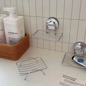 Detail of suction cup soap holders with stainless steel mesh in a modern bathroom setup