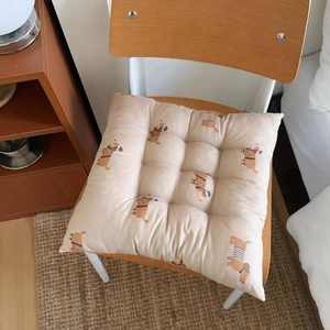 Macro detail of square seat cushion with floral dachshund print and quilted surface