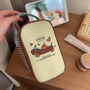 Detail of insulated lunch bag featuring cartoon dachshund print and plaid handles