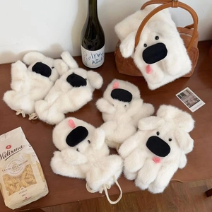 Detail von flauschigen weißen Hunde-Handschuhen und Halstasche auf einem rustikalen Holztisch