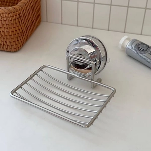 Close-up of a wall-mounted stainless steel soap dish with vacuum suction cup for drainage