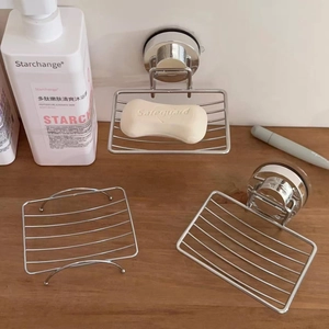 Detail of wall-mounted suction cup soap dish and stainless steel wire drainage racks