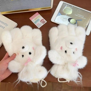 Close-up of white plush puppy mittens with pink bow accents and a knitted safety cord