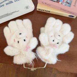 Detail of plush white fleece mittens featuring 3D cartoon bear faces and plaid bows