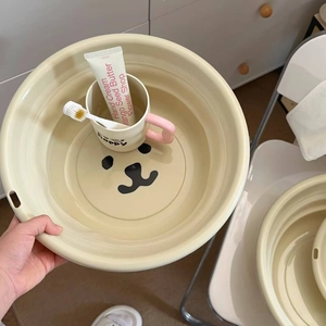 Collapsible cream washbasin with cute bear face design for home and travel use