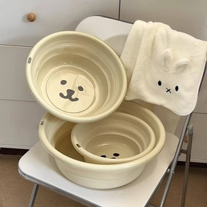 Three-piece set of cream collapsible basins with cute bear prints in a home setting
