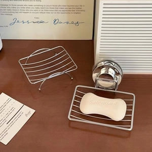 Detail of stainless steel soap dish set with suction cup mount and mesh drainage grid