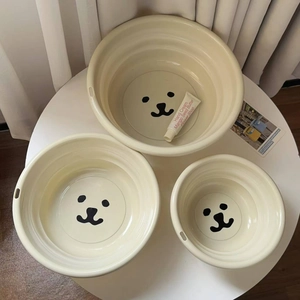 Three-piece nesting bear washbasin set in beige plastic with space-saving hanging holes