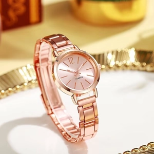 Detailed close-up of rose gold steel watch strap with polished and brushed link textures