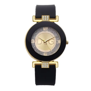 Women's fashion watch with gold case, rhinestone dial, and black silicone strap