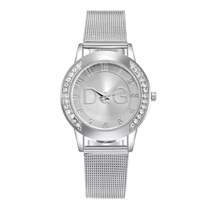 Detailed macro view of silver mesh watch dial with sparkling rhinestones and logo