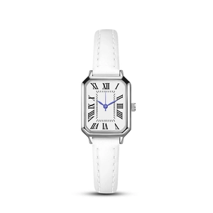 Detail of square silver watch case with Roman numerals and white leather strap