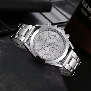 Detail of silver steel business watch with Roman numerals and three-eye chronograph dial