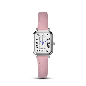 Detail of pink leather watch strap with silver square case and blue hands on white dial