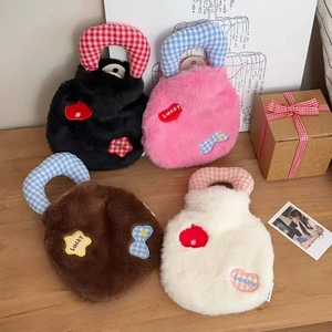 Detail of plush hot water bags in four colors with Lucky embroidery and checkered handles