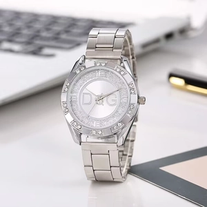 Detailed view of silver stainless steel watch with crystal bezel and luxury metal strap