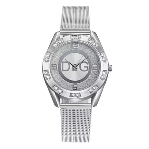 Detail of silver mesh watch band with sparkling diamond bezel and quartz dial