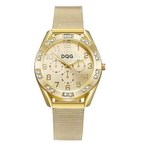 Detail of gold alloy watch case featuring sparkling rhinestones and a mesh metal strap