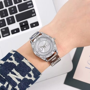 Close-up of luxury women's quartz watch with crystal bezel and silver link strap
