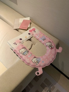 Detail of pink waterproof EVA toilet seat cover with cute cat prints and wavy edges