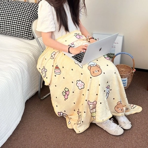 Close-up of soft coral fleece blanket with cute cartoon bear and dessert patterns