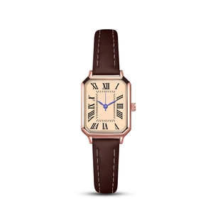 Macro view of octagonal rose gold watch case with blue hands and Roman numerals