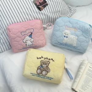 Quilted cosmetic bags with plush animal embroidery in pink, blue and yellow