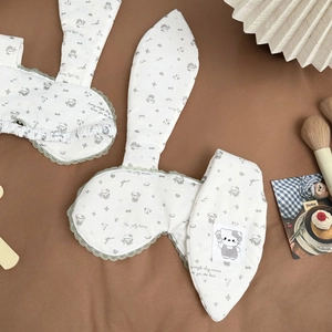 Cute bunny ear sleep masks with lace trim and bear patterns on a brown background