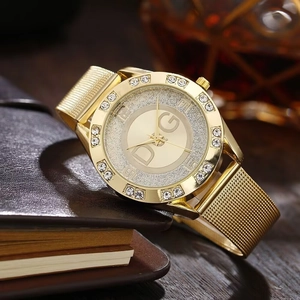 Close-up of gold Milanese mesh strap and crystal-encrusted bezel on a luxury ladies watch