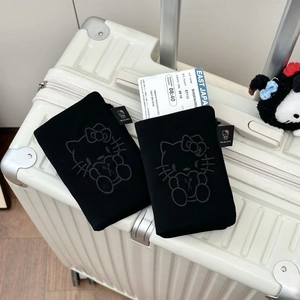 Premium black passport holder set with Hello Kitty embroidery on travel suitcase