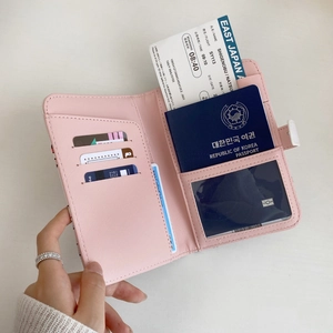Pink faux leather multi-functional passport holder with card slots and magnetic closure