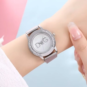 Close-up of silver mesh strap women's quartz watch with crystal-encrusted bezel and dial
