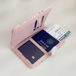 Pink passport wallet interior featuring multiple card slots and clear ID window for travel