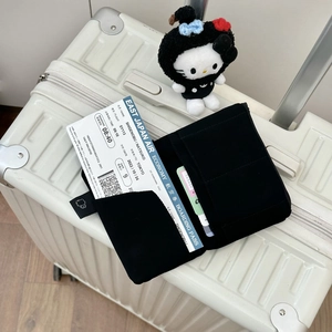 Detailed view of black travel organizer showing card slots and ticket compartments