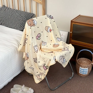 Soft cream flannel blanket with cute cartoon bear and strawberry prints for cozy home use
