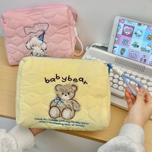 Detailed view of quilted cotton travel bags with bear and puppy animal embroidery