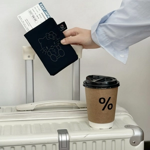 Close-up of black canvas travel passport holder featuring a cute cartoon cat embroidery