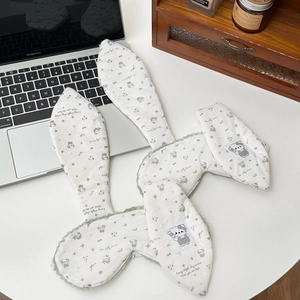 Detail of bunny ear sleep masks with green lace trim and cute cartoon cat patterns