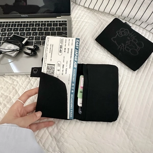 Detail of Hello Kitty black passport holder showing interior pockets for tickets and cards