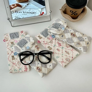 Detailed view of quilted cotton glasses pouches with cute bear and floral patterns